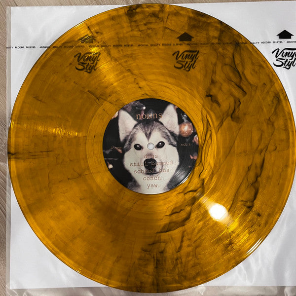 Nouns Still Bummed limited edition orange, black swirl vinyl record and label